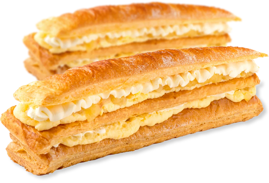 A Corica apple strudel with a slice cut away, showing layers of flaky pastry, apple, custard and fresh cream